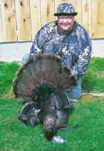 Hunter with turkey bagged while hunting at Ten Point Lodge LLC